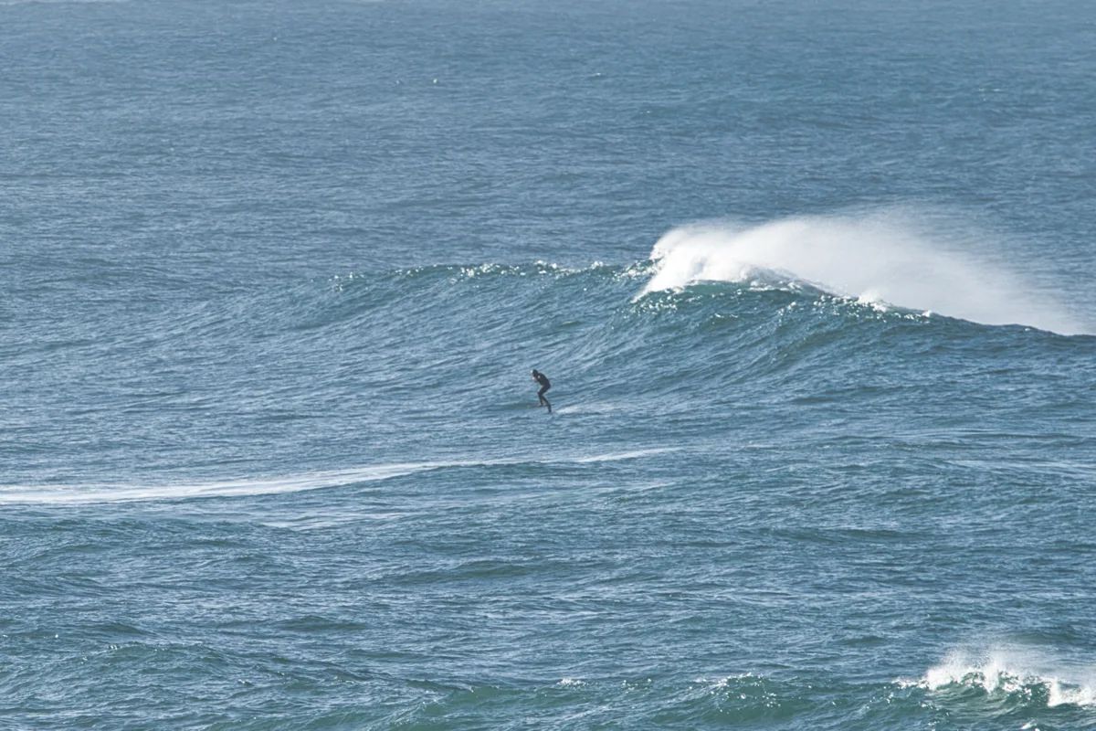 A foiler dropping into a clean Atlantic wave off Vila Nova de Milfontes