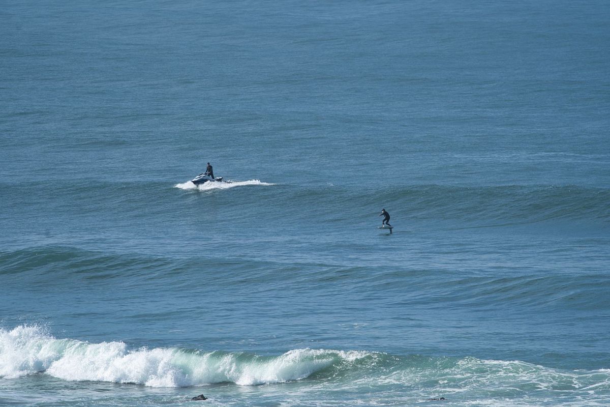 Jet ski towing a foiler into a wave on Portugal’s Alentejo coast